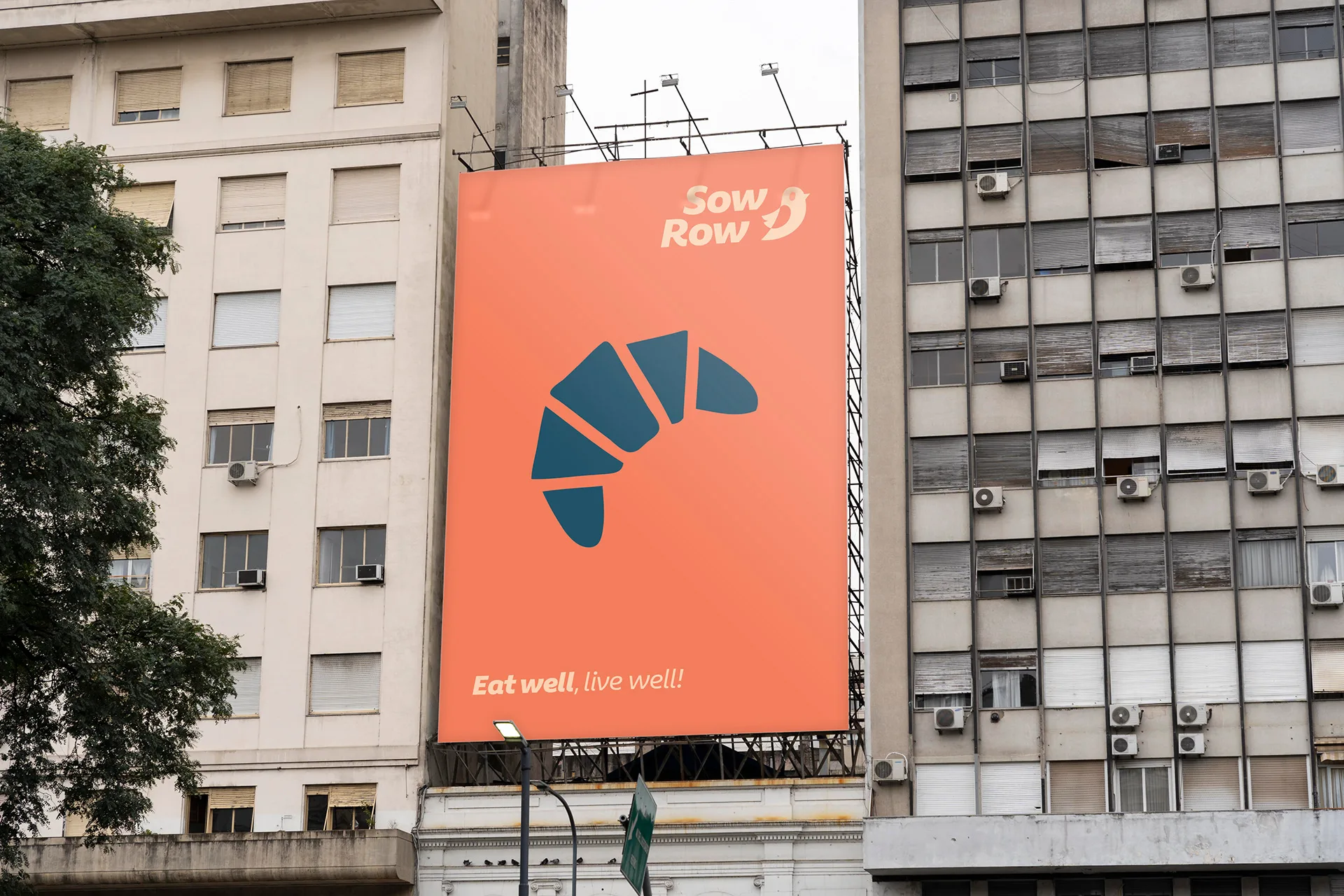 Sow Row — a coral Sow Row billboard on a concrete facade
