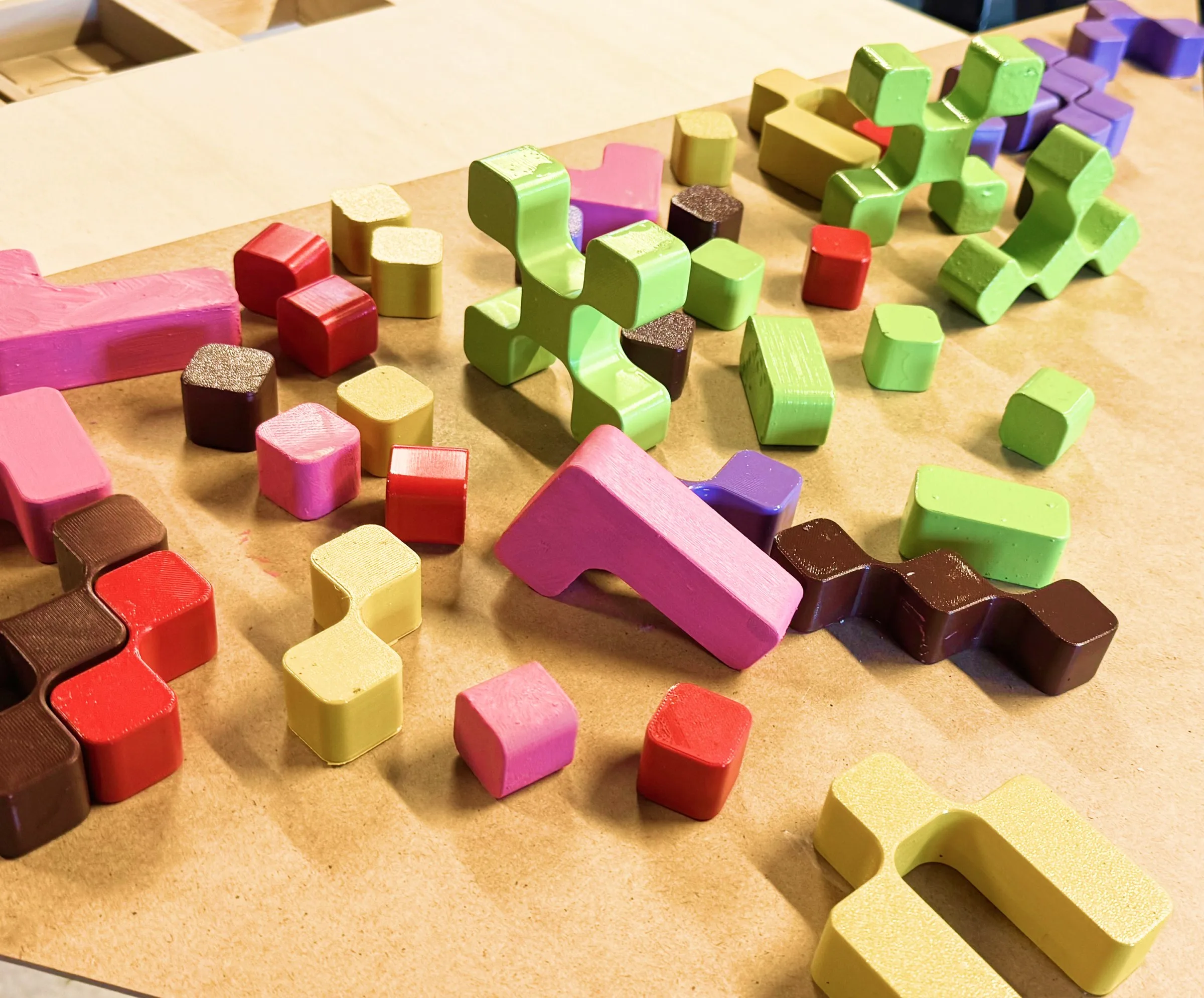 Morpho — hand-painted puzzle pieces drying on a bench