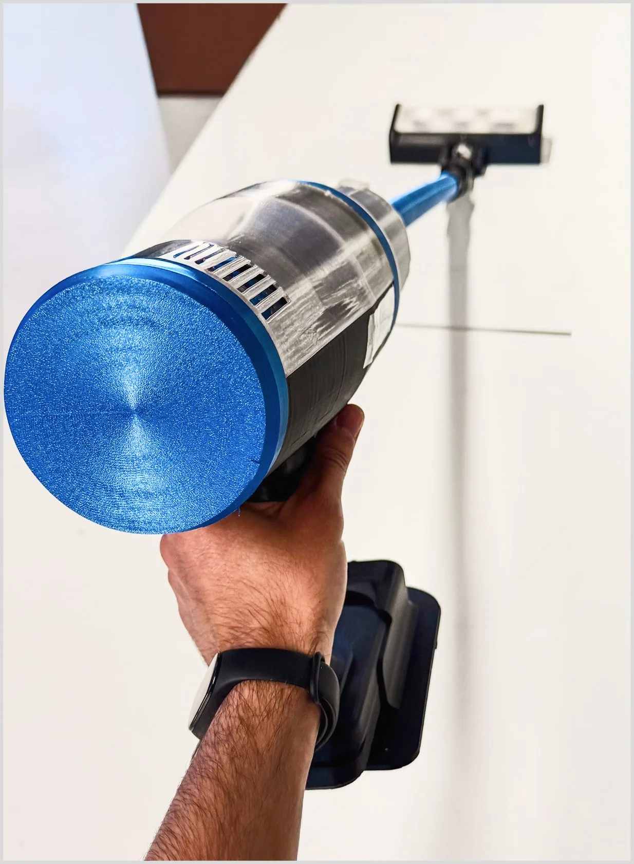 Luma — the blue prototype held against a wall